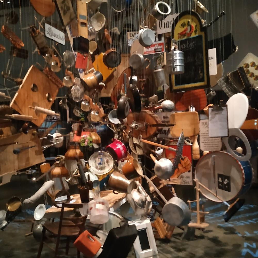 A large installation of hanging household items.